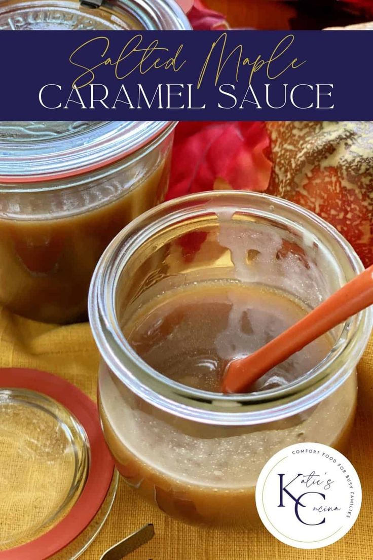 two jars filled with caramel sauce sitting on top of a table next to spoons