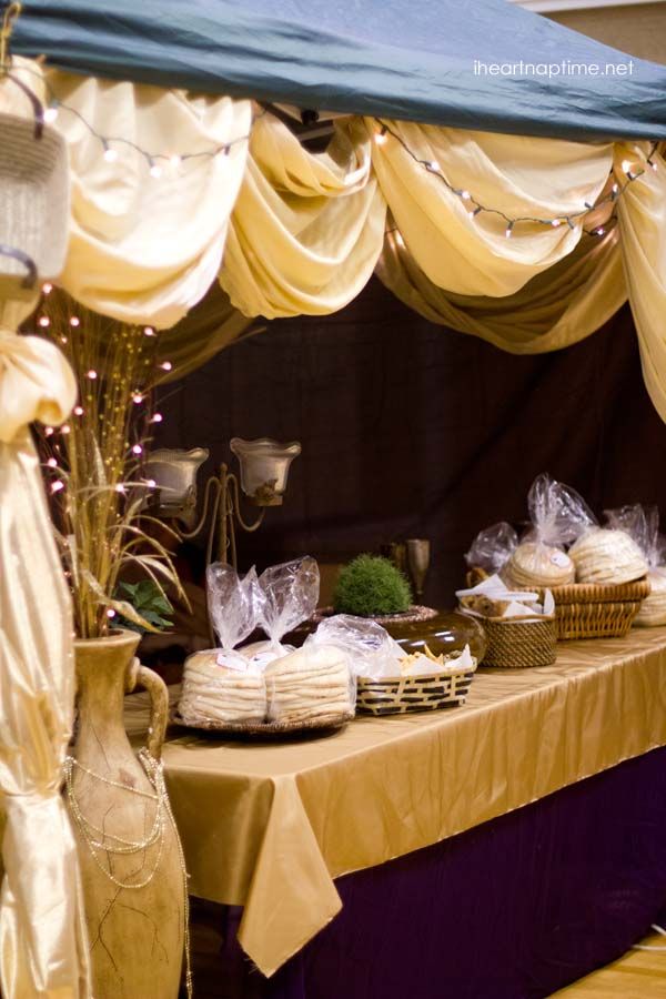 a table covered with lots of food under a canopy