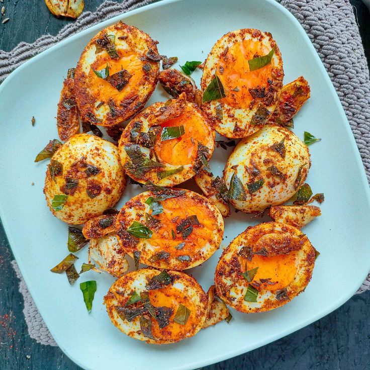 baked eggs with herbs on a white plate