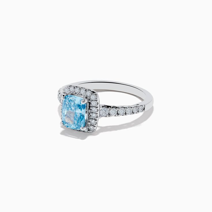 a blue and white diamond ring on a white background