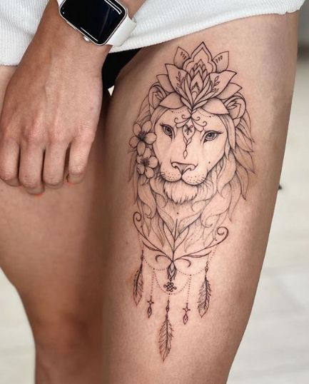 a woman's thigh with a lion tattoo on it