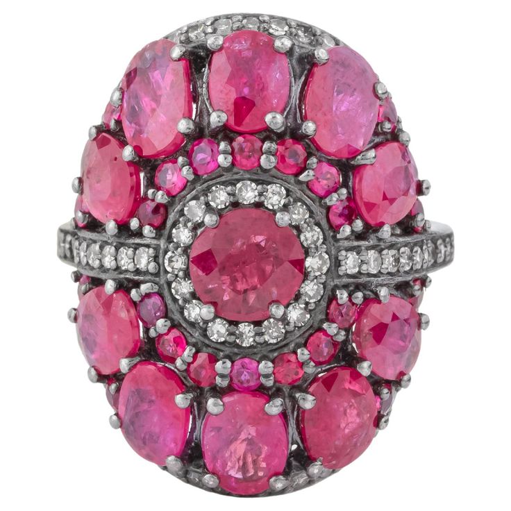 The 6.72 Carat Diamond and Ruby Cluster Ring epitomizes luxury and refined craftsmanship, combining the timeless allure of diamonds with the vibrant beauty of rubies. This ring features a stunning cluster design, where carefully selected gemstones are arranged in a captivating display of brilliance and color. At the center of the ring, a collection of dazzling diamonds forms a radiant focal point. These diamonds, totaling 6.72 carats, are chosen for their exceptional clarity and brilliance. Each diamond is meticulously set to maximize its sparkle, creating a mesmerizing effect that captures light from every angle. The cluster setting ensures that the diamonds are securely held, allowing for a seamless and dazzling presentation. Surrounding the central diamonds, vivid rubies add a rich, con Cluster Design, Contemporary Ring, All Gems, Deep Red Color, Ruby Stone, Modern Ring, Diamond Cluster Ring, Gem Stone, Diamond Cluster