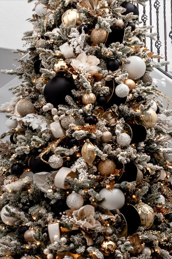 a decorated christmas tree with black and gold ornaments