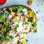 a pizza sitting on top of a table covered in toppings