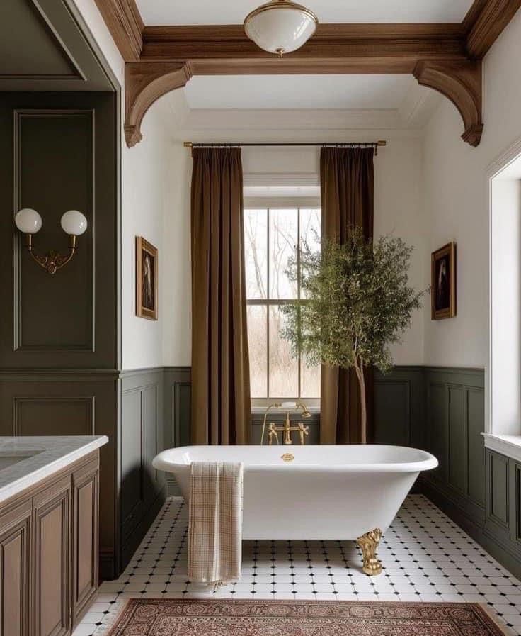 a bath tub sitting under a window next to a potted plant in a bathroom