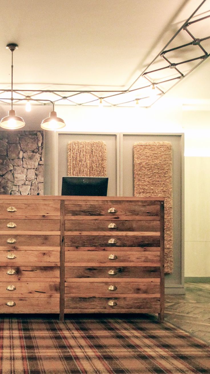 a large wooden dresser sitting on top of a carpeted floor next to a wall