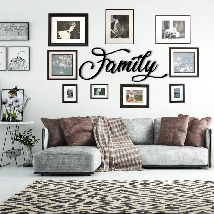 a living room filled with furniture and lots of framed pictures on the wall above it