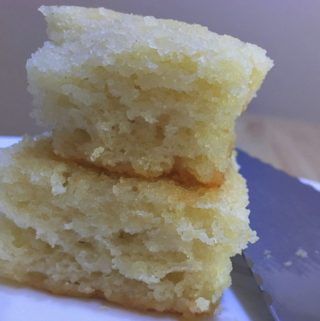 two pieces of cake sitting on top of a white plate with a knife next to it