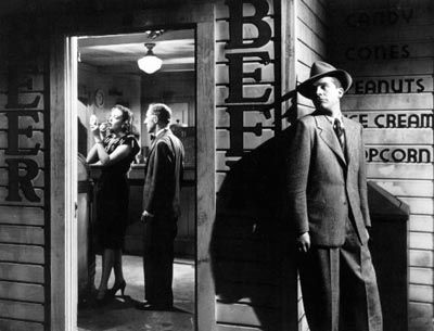 an old black and white photo of three men standing in front of a storefront