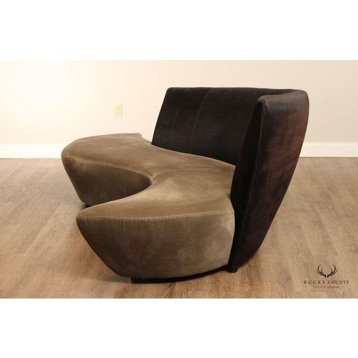 a brown and black chair sitting on top of a hard wood floor