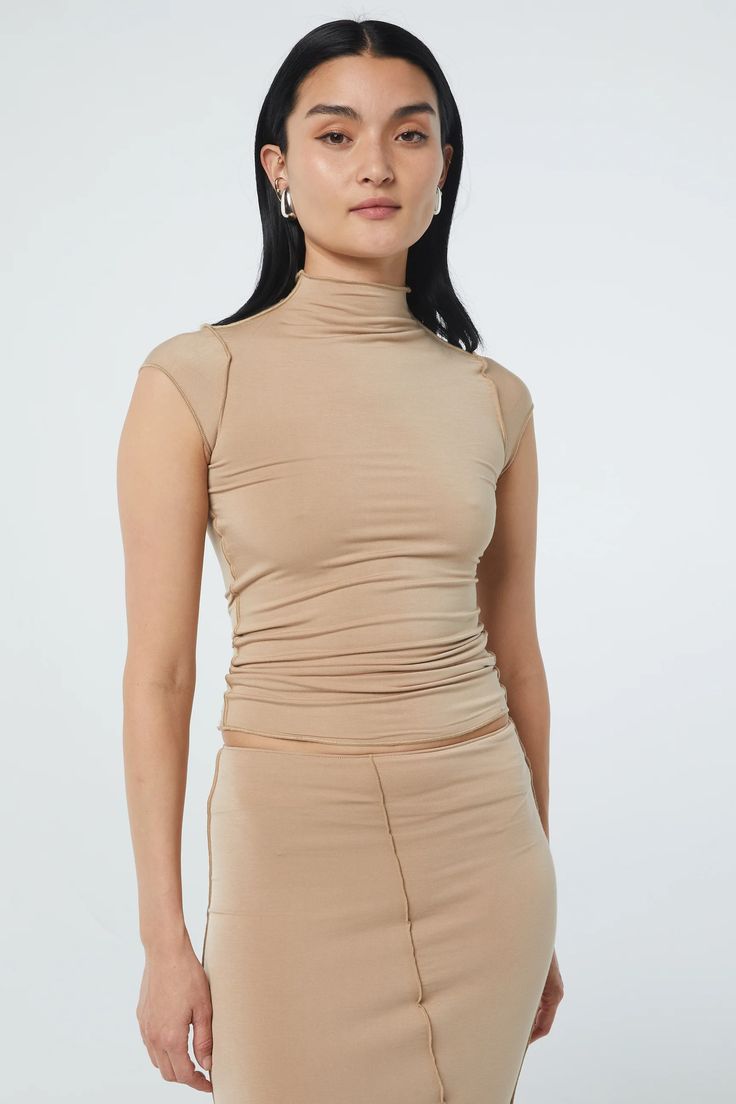 Solid Color Stretch Tops With Funnel Neck, Versatile High Neck Tops For Layering, Elastane Turtleneck Top, Chic Fitted Cap Sleeve Tops, Chic Beige High Stretch Top, Fitted Mock Neck Turtleneck Top, Chic Fitted Tops With Cap Sleeve, Chic High Stretch Beige Tops, Versatile Fitted High Neck Mock Neck Top