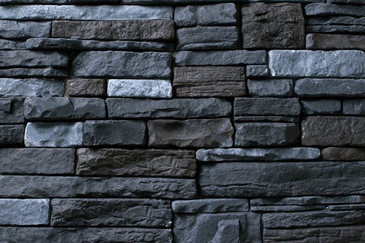 a black stone wall is shown in this image