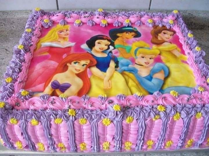 there is a cake with princesses on it