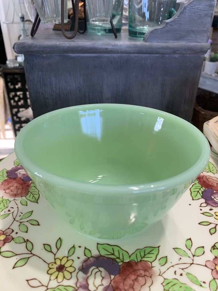 a green bowl sitting on top of a table