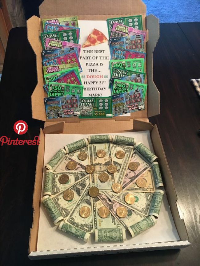 a pizza box with money in it sitting on a table