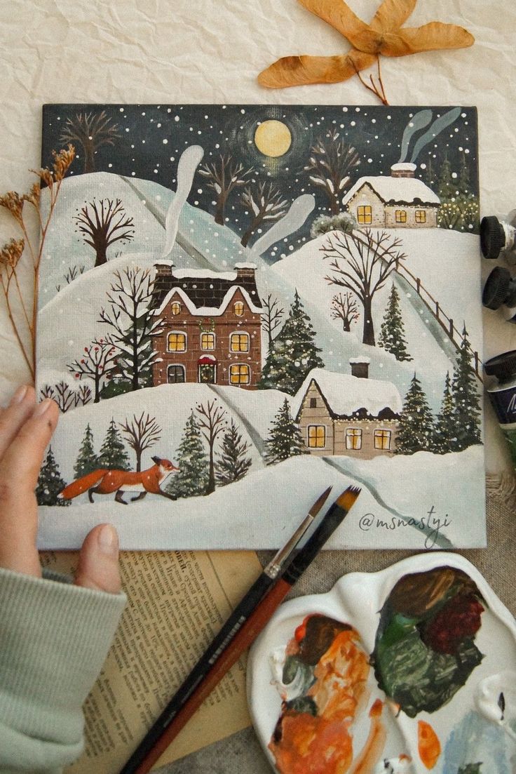 someone is painting a winter scene on a piece of paper