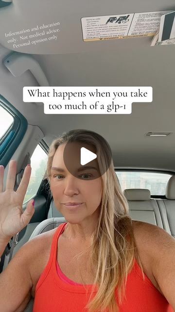 a woman sitting in the back seat of a car with her hand up and another person standing next to her