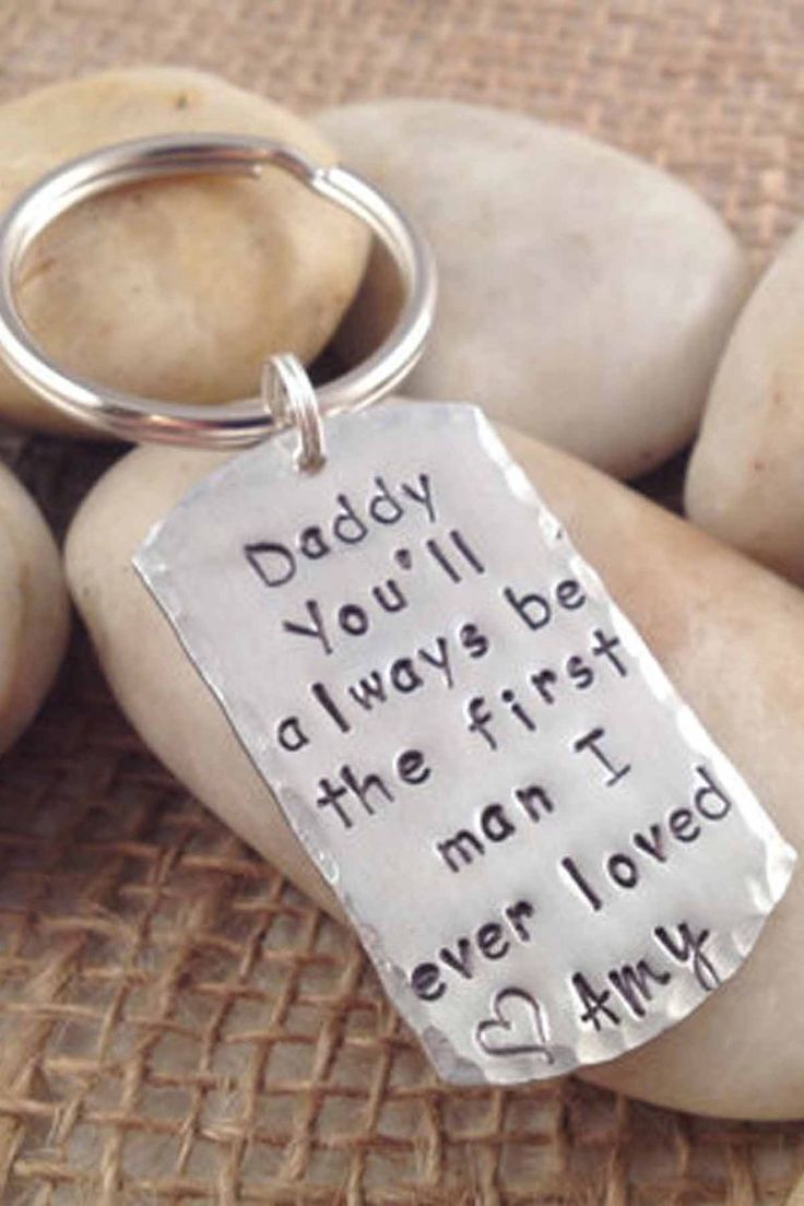 a metal keychain that says daddy you'll always be the first man i ever loved