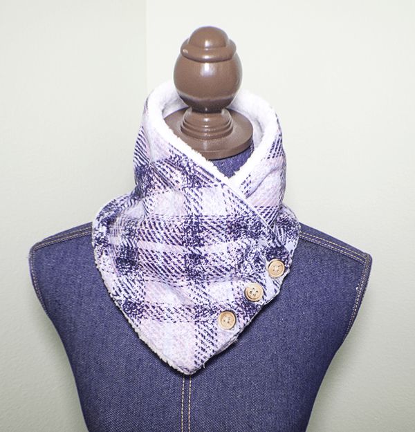 a mannequin wearing a blue and white plaid scarf on it's neck