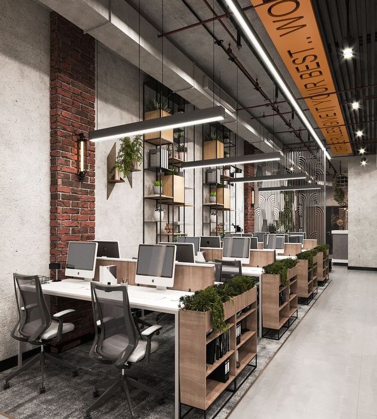 an office with desks, chairs and shelves filled with plants in the middle of it