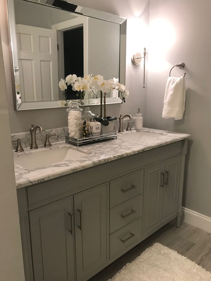 a bathroom with two sinks and a large mirror