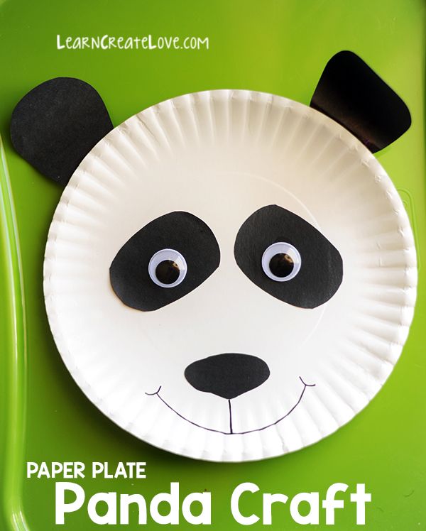 a paper plate panda craft on a green tray