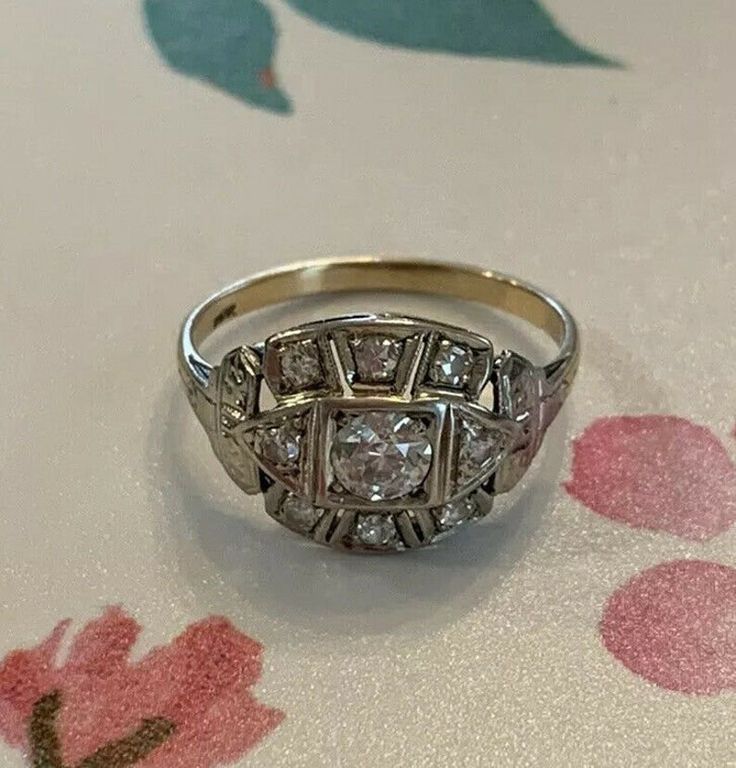 an antique diamond ring sitting on top of a table