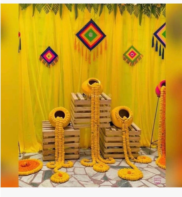 some yellow decorations are sitting on pallets in the middle of a room with curtains