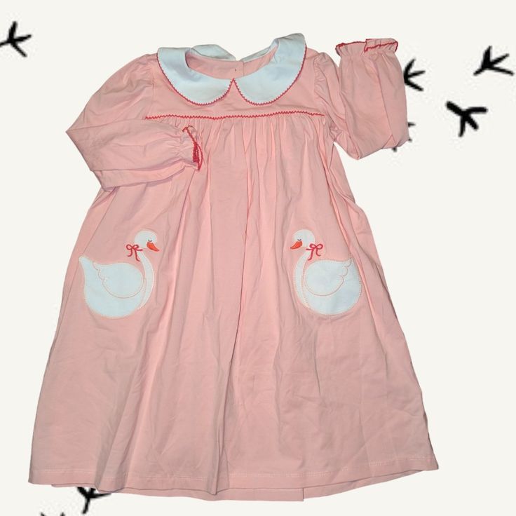 Whether She Is A Swan Princess Or A Queen, Your Daughter Is Sure To Love This Adorable, Classic Style, Swan Pocket Dress. It Features Soft Apricot Cotton Fabric, Which Is Sure To Keep Her Happy All Day Long, Red Picot Detailing Around The White Collar And Ruffle Sleeves, And Applique Giant Swan Front Pockets. This Sweet Dress Is Perfect For All Activities, Back To School, And Maybe A Disney Trip! Made From The Softest 100% Cotton For Ultimate Comfort Custom Red Buttons Down The Back Red Picot Tr Cute Long Sleeve Dress For Dress-up, Cute Long Sleeve Dress-up Dresses, Cute Spring Twirl Dress For Sleepovers, Long Sleeve Playful Twirl Dress For Playdate, Playful Ruffled Dress For Sleepovers, Playful Long Sleeve Twirl Dress For Playdate, Playful Long Sleeve Dresses For Sleepover, Fitted Playful Dress For Sleepover, Long Sleeve Twirl Dress For Summer Playtime