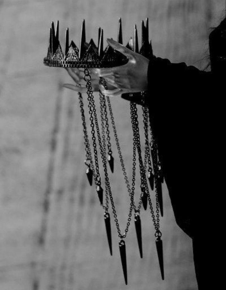 black and white photograph of a woman holding a tray with spikes on it