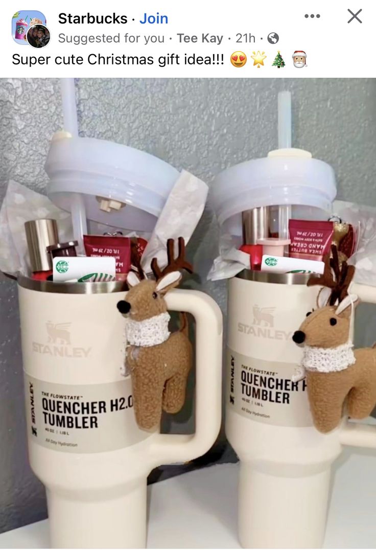 two coffee mugs with reindeer decorations on them, one is filled with toothbrushes