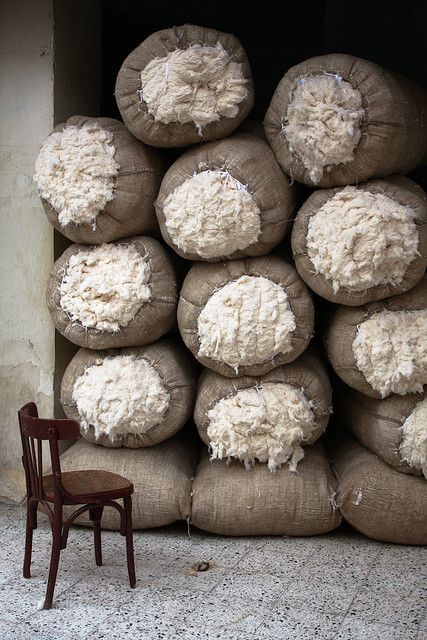 a pile of sand bags sitting next to a chair