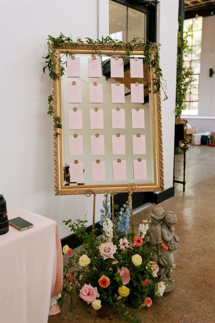 a table with a sign and flowers on it