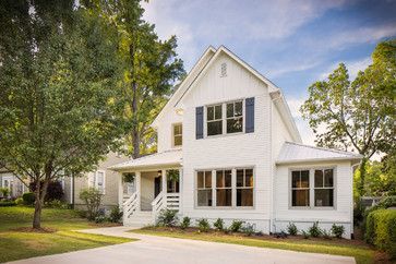 a white house with black shutters and trees