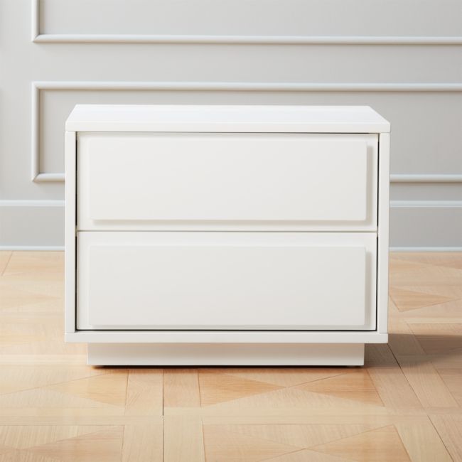 a white dresser sitting on top of a hard wood floor