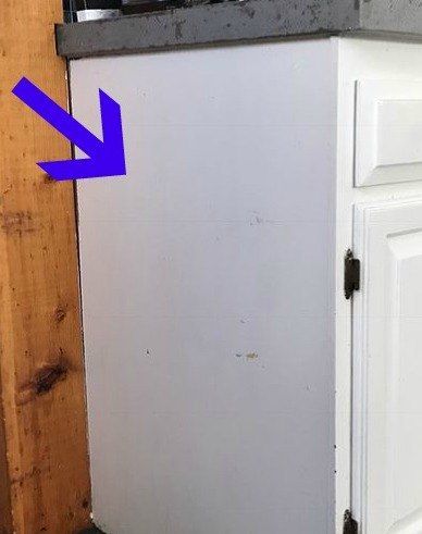 a white refrigerator freezer sitting inside of a kitchen next to a wooden counter top