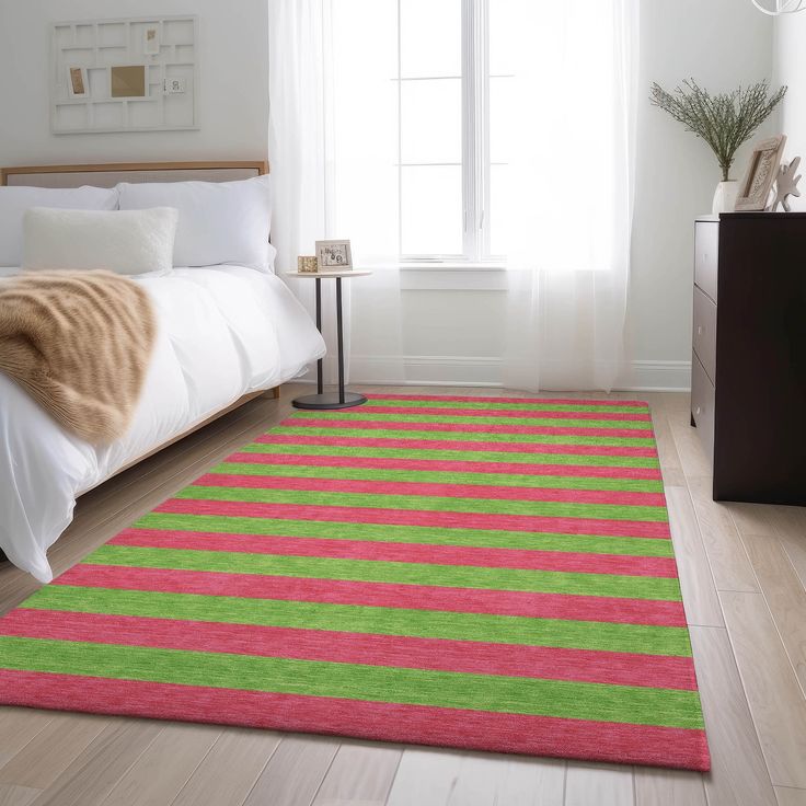 a bed room with a neatly made bed and a rug