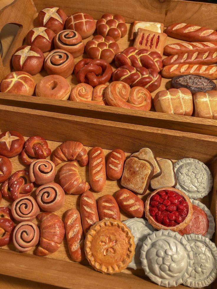 two wooden trays filled with different types of pastries