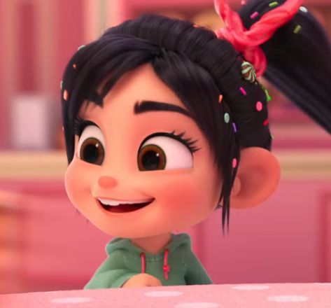 an animated character with black hair wearing a green shirt and pink polka dot headband