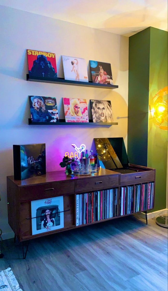 an entertainment center in a living room filled with cds