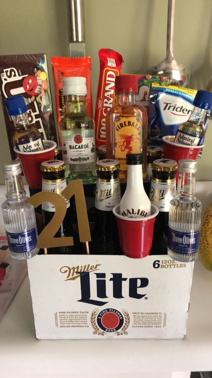 an assortment of liquors and condiments in a box on a counter top