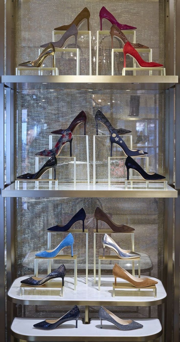 a display case filled with lots of different types of high heeled shoes on shelves