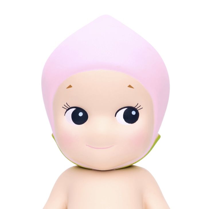 a small doll with a pink hat on it's head and big blue eyes