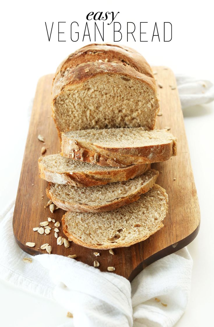 sliced loaf of bread sitting on top of a wooden cutting board