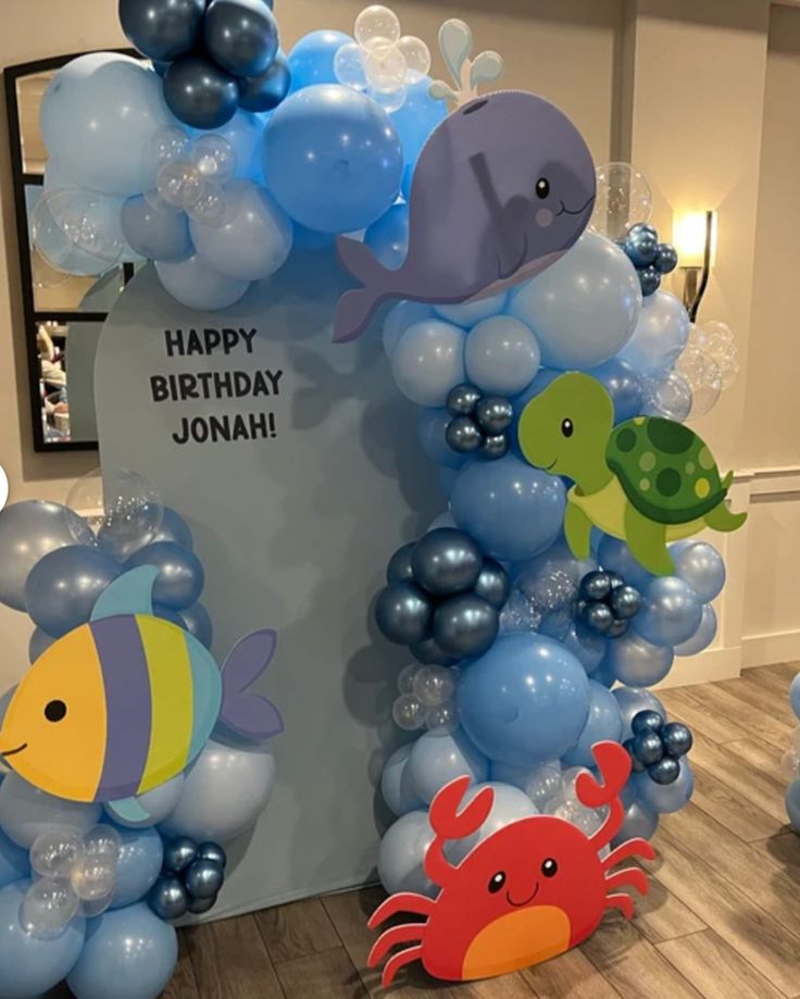 some balloons are set up in the shape of fish and sea animals for a children's birthday party