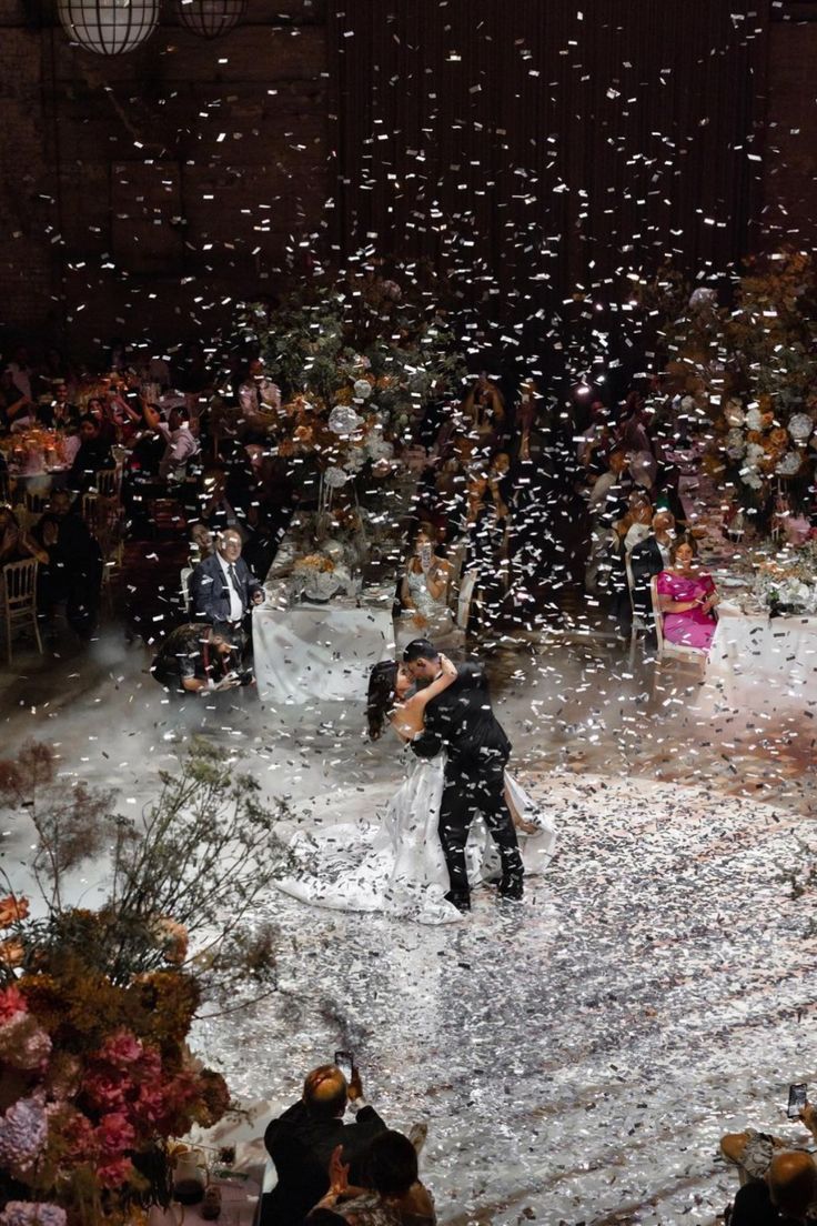 a bride and groom are surrounded by confetti