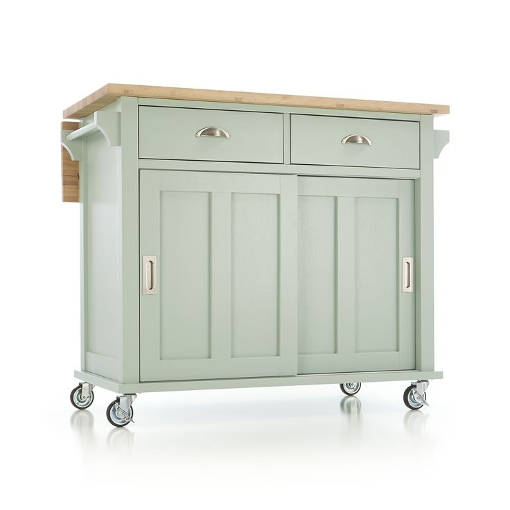 a green kitchen island with two drawers on wheels