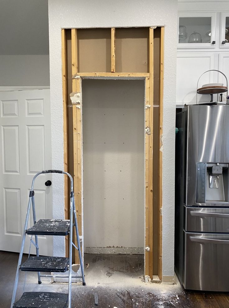 a ladder is in front of a door that has been built into the wall