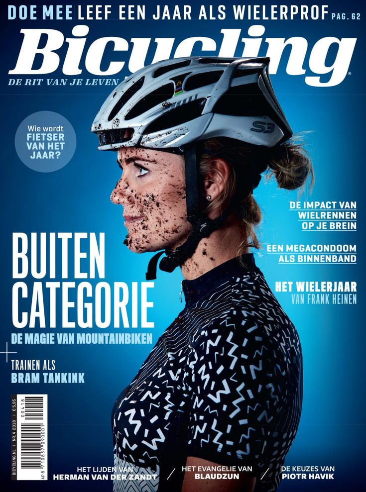 a man wearing a helmet on the cover of a bike magazine, with mud all over his face