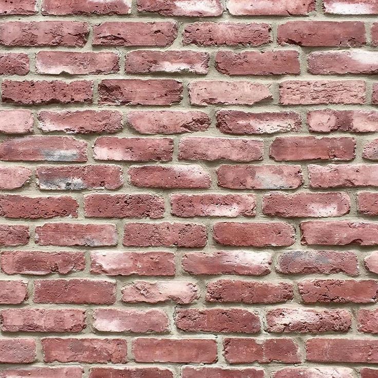 a red brick wall that is very close to the ground